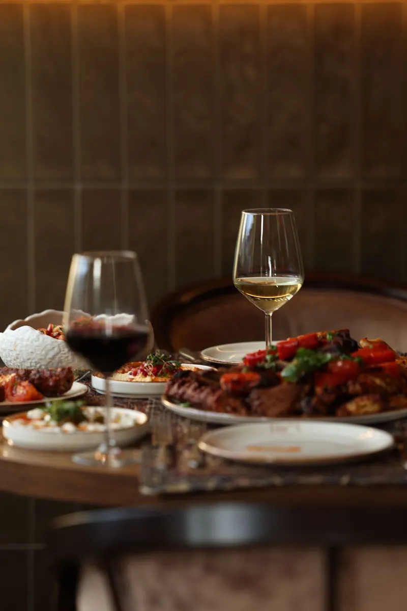 Dinner table with grill plates and wine