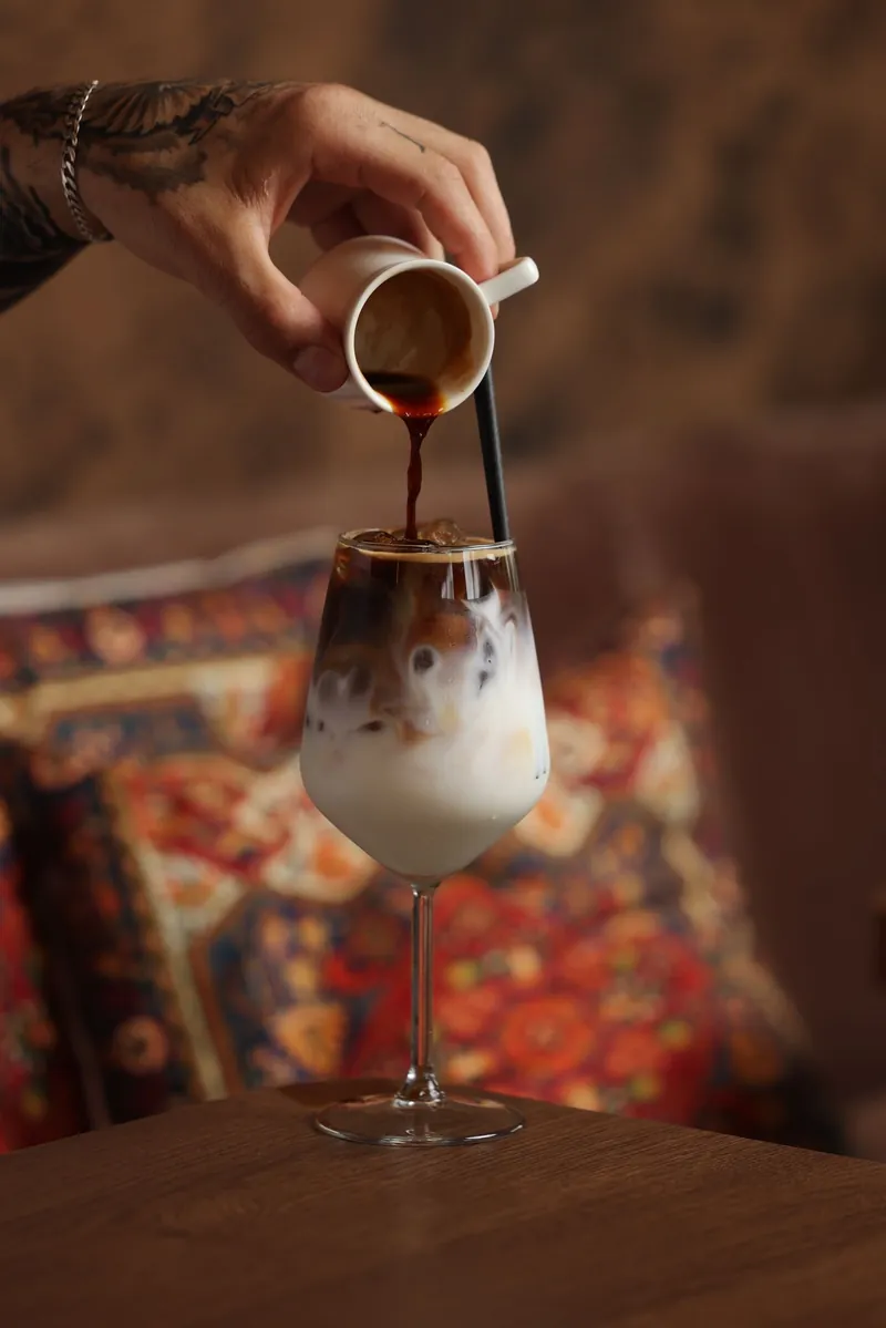 Espresso poured over an iced latte