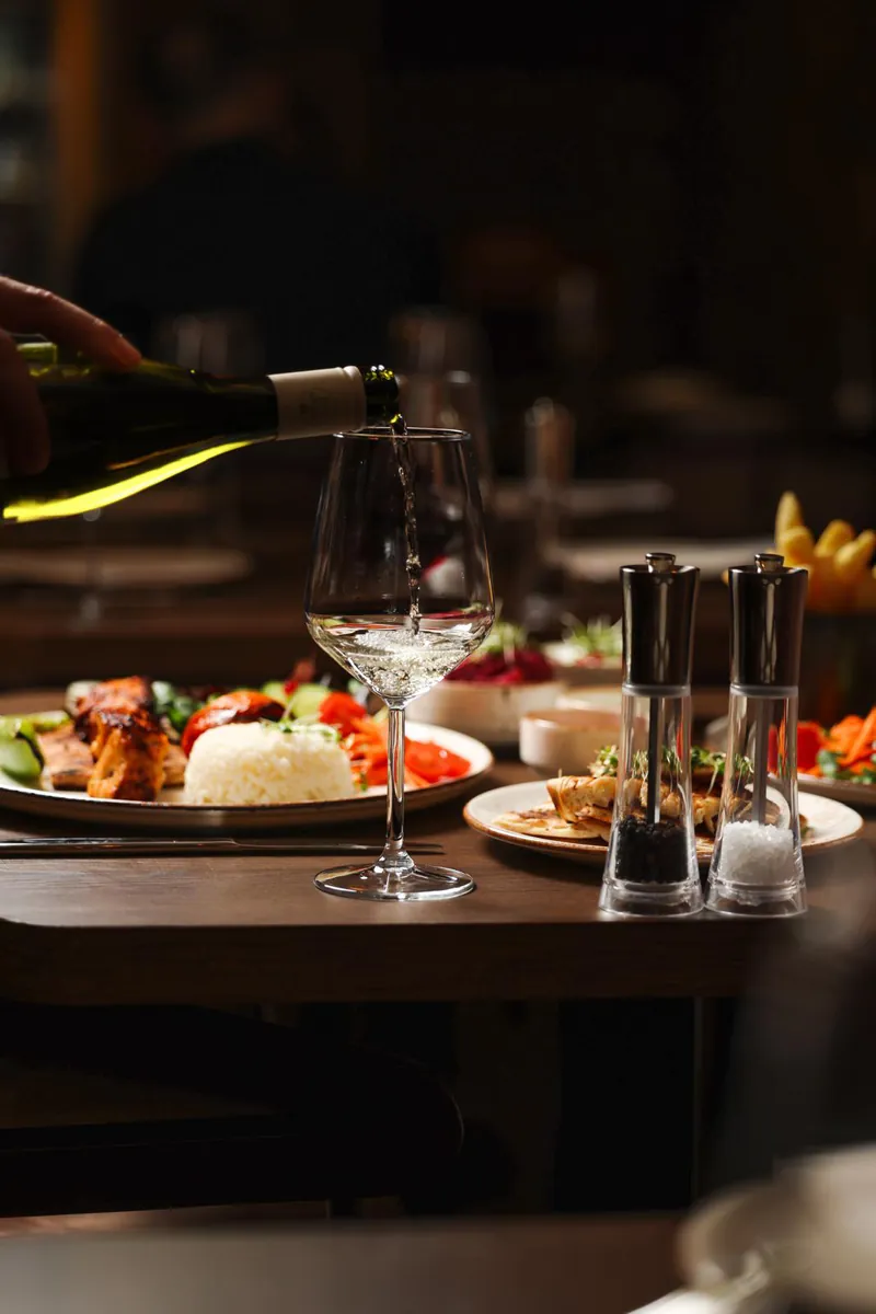 White wine being poured at the table